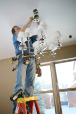 stock-photo-4909884-electrician-installing-chandelier